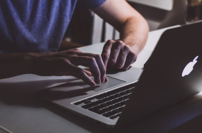 Man typing conference paper