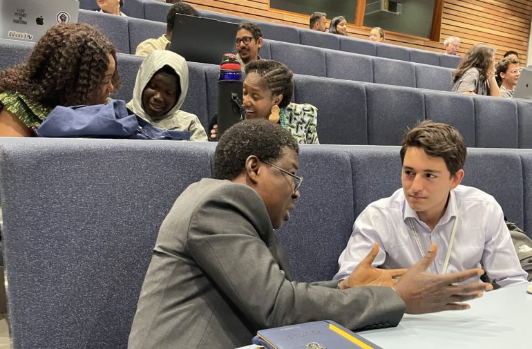 Ignacio Feged talks to a fellow delegate in a discussion on what kind of economist are you?